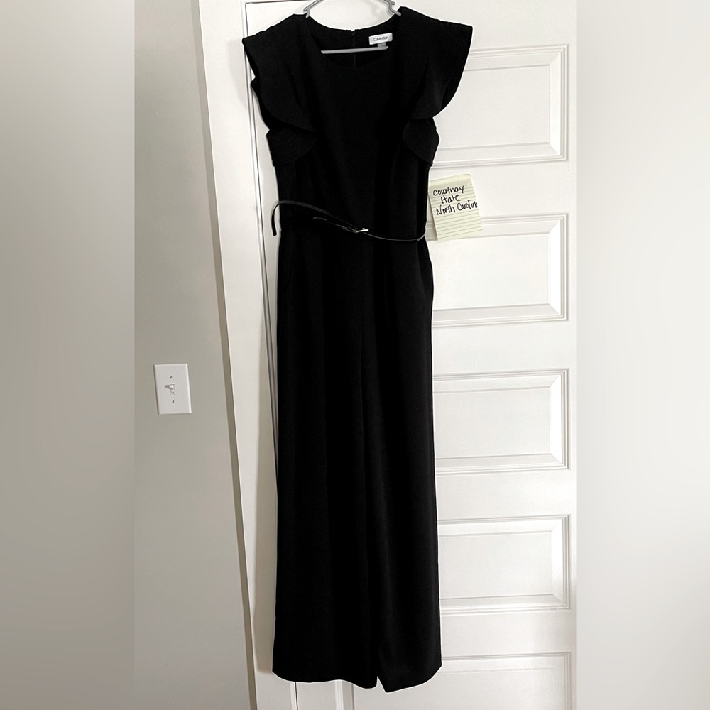 Black Calvin Klien belted jumpsuit. Has beautiful ruffled sleeves. EUC. size 14